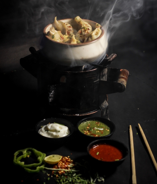 Steaming momos served with local chutneys